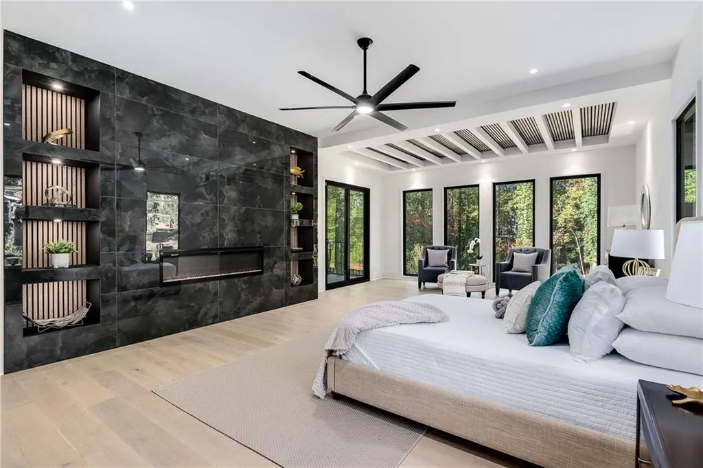 Primer Bedroom with a fireplace, wood finished floors, beam ceiling, tile walls, and recessed lighting