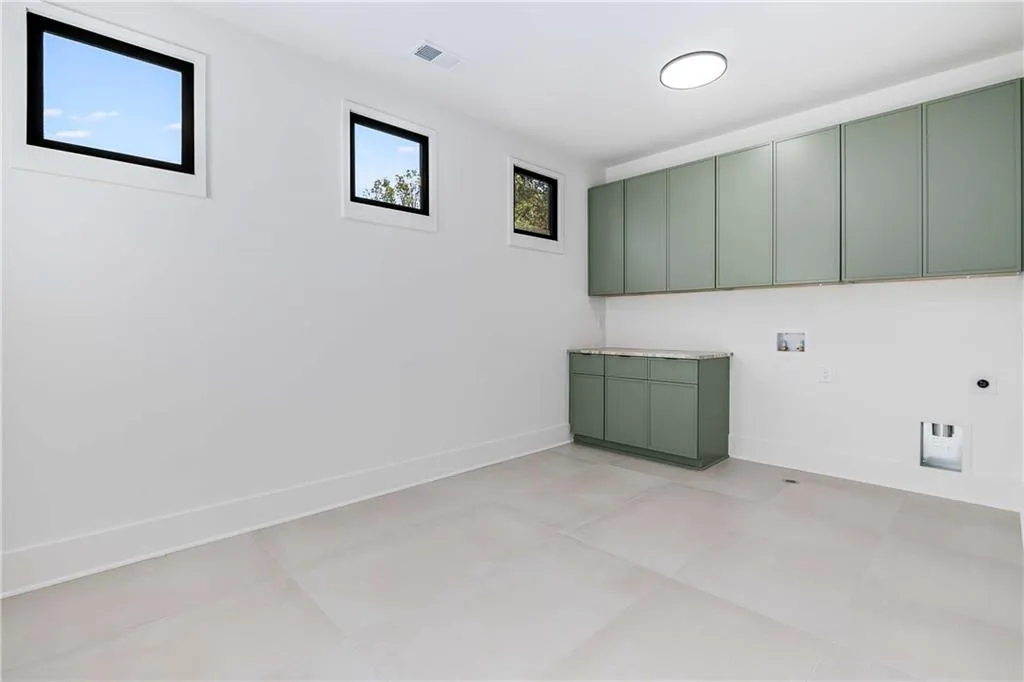 Laundry area with cabinet space, washer hookup, and hookup for an electric dryer
