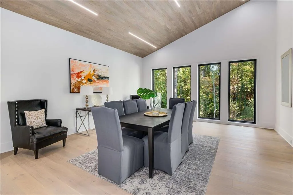 Dining space featuring light wood-style floors, high vaulted ceiling, and wooden ceiling
