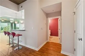 Hall with wood finished floors and baseboards