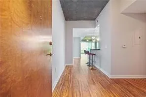 Corridor with wood finished floors and baseboards