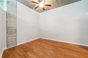 Spare room featuring a ceiling fan and wood finished floors
