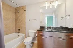 Full bath featuring vanity and  shower combination