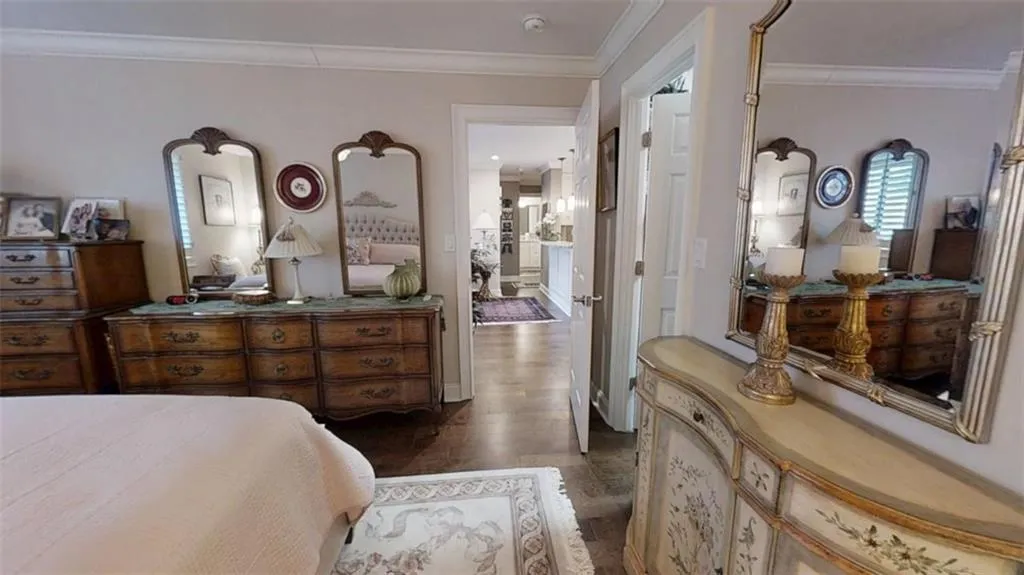 Bedroom featuring dark wood finished floors and crown molding