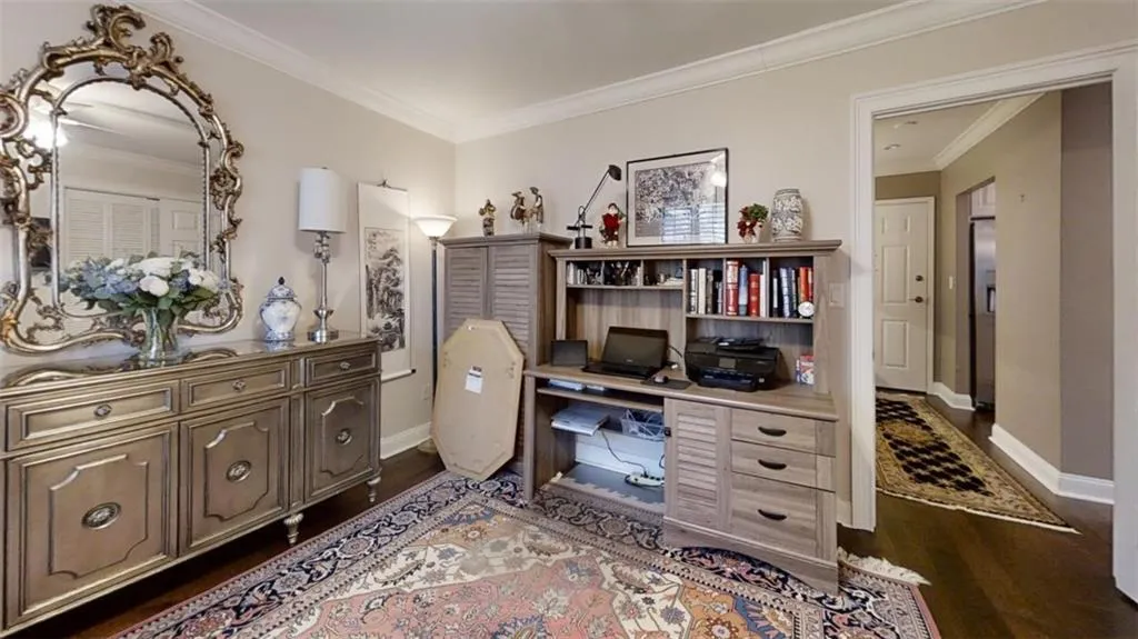 Home office featuring baseboards, dark wood finished floors, and crown molding