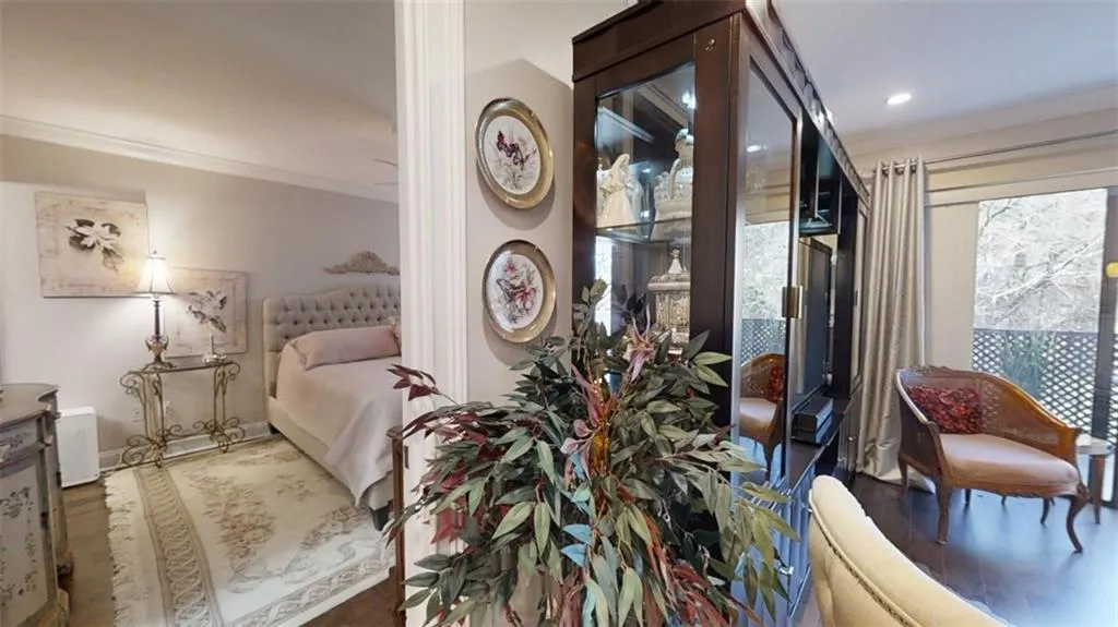 Bedroom with crown molding, baseboards, and wood finished floors
