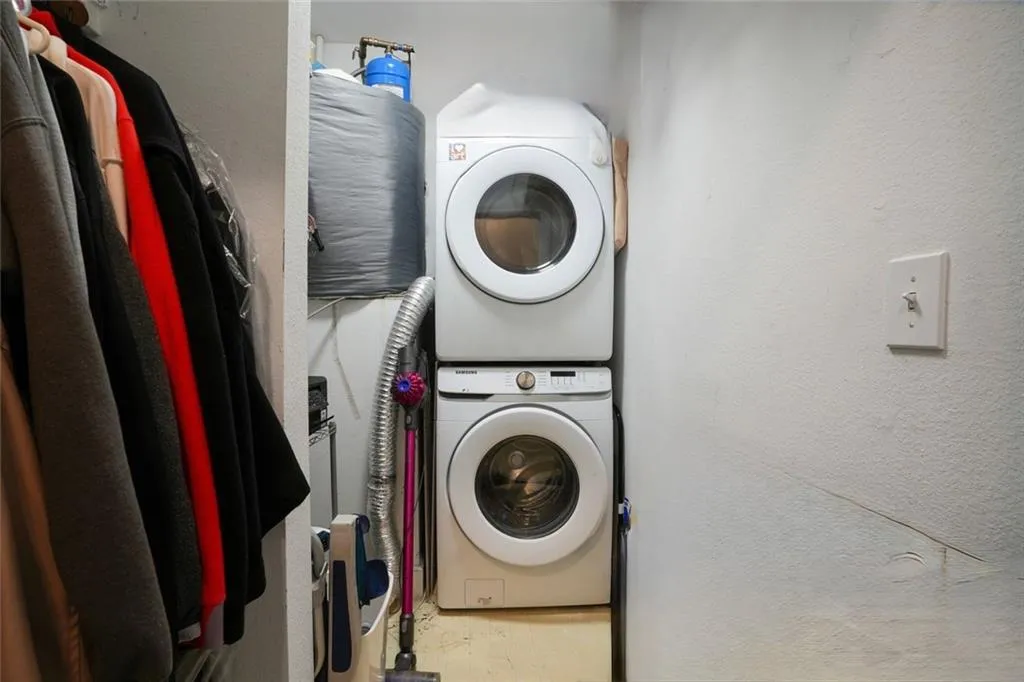 Dedicated Laundry Room with Stacked Washer and Dryer that Remain with the Property,