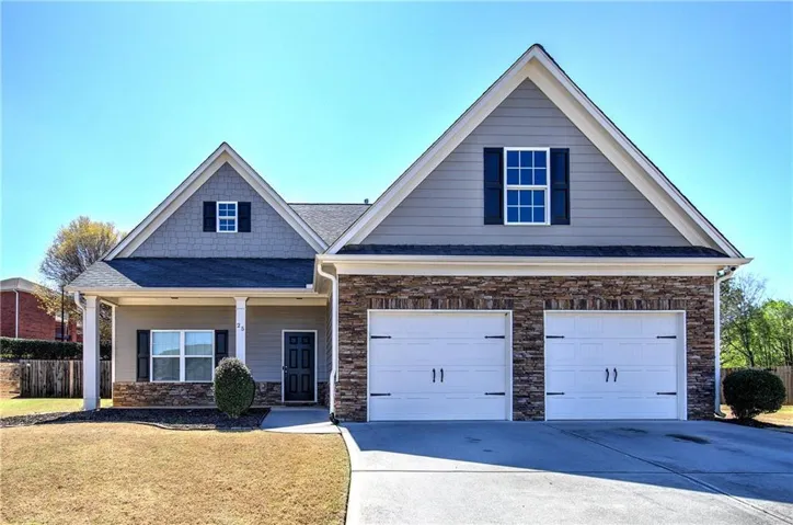 View of front of home featuring a porch, driveway, and an attached garage