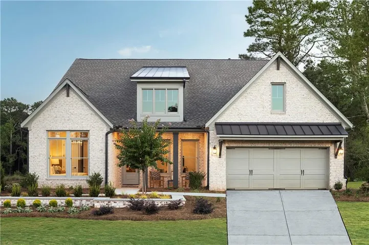 White brick exterior with a dark shingle roof, complemented by a metal roof dormer