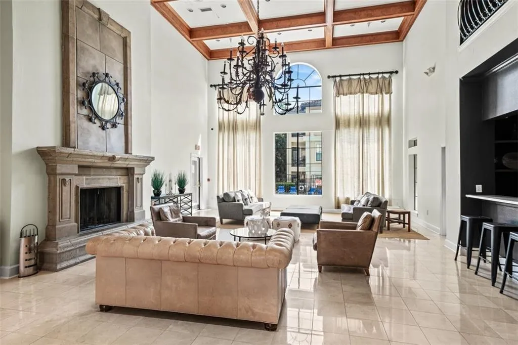 Common area featuring a high ceiling, coffered ceiling, and beamed ceiling