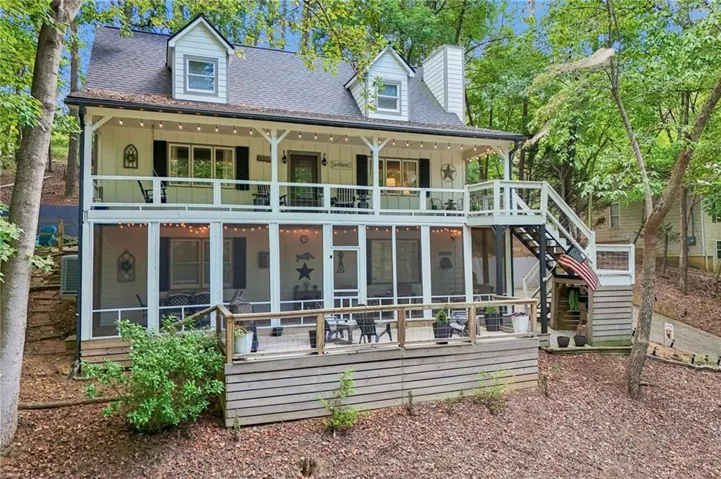 Two-story residence featuring a screened porch, an open-air deck, a balcony, and dormer windows
