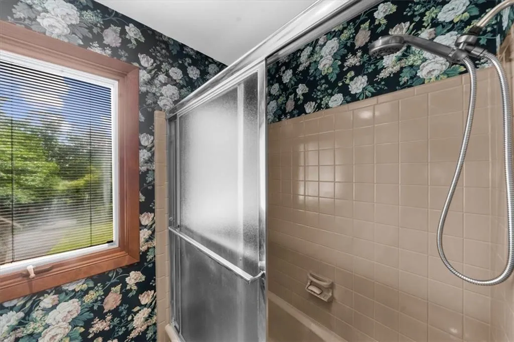 Full bathroom featuring wallpapered walls
