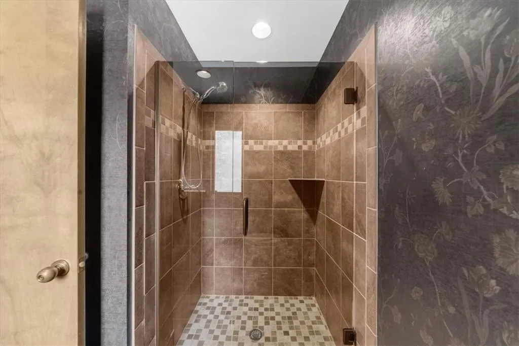 Bathroom featuring a stall shower and recessed lighting