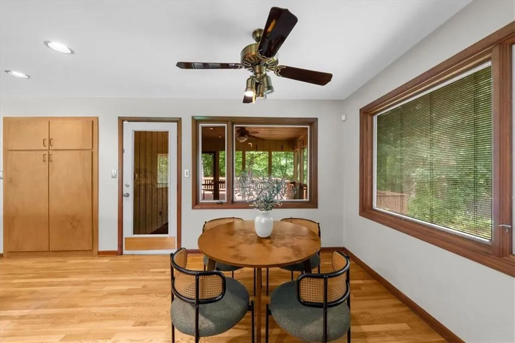Dining space with baseboards, a ceiling fan, light wood-type flooring, and recessed lighting