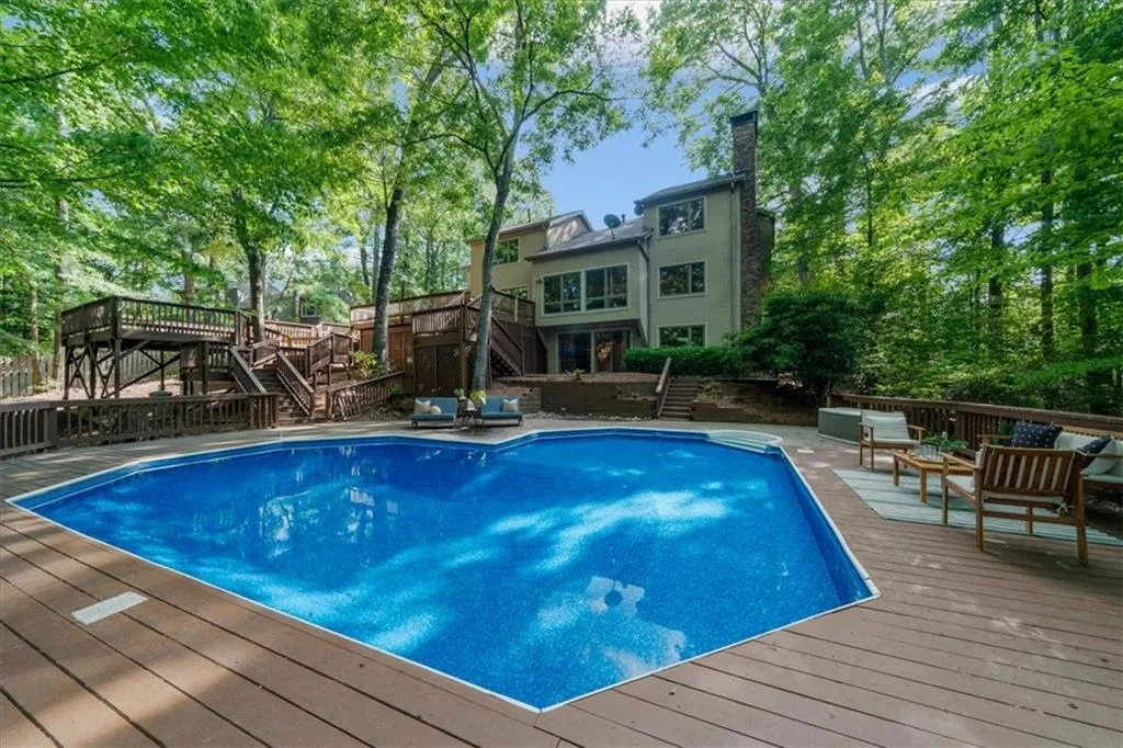 View of swimming pool featuring stairs, a deck, and outdoor lounge area