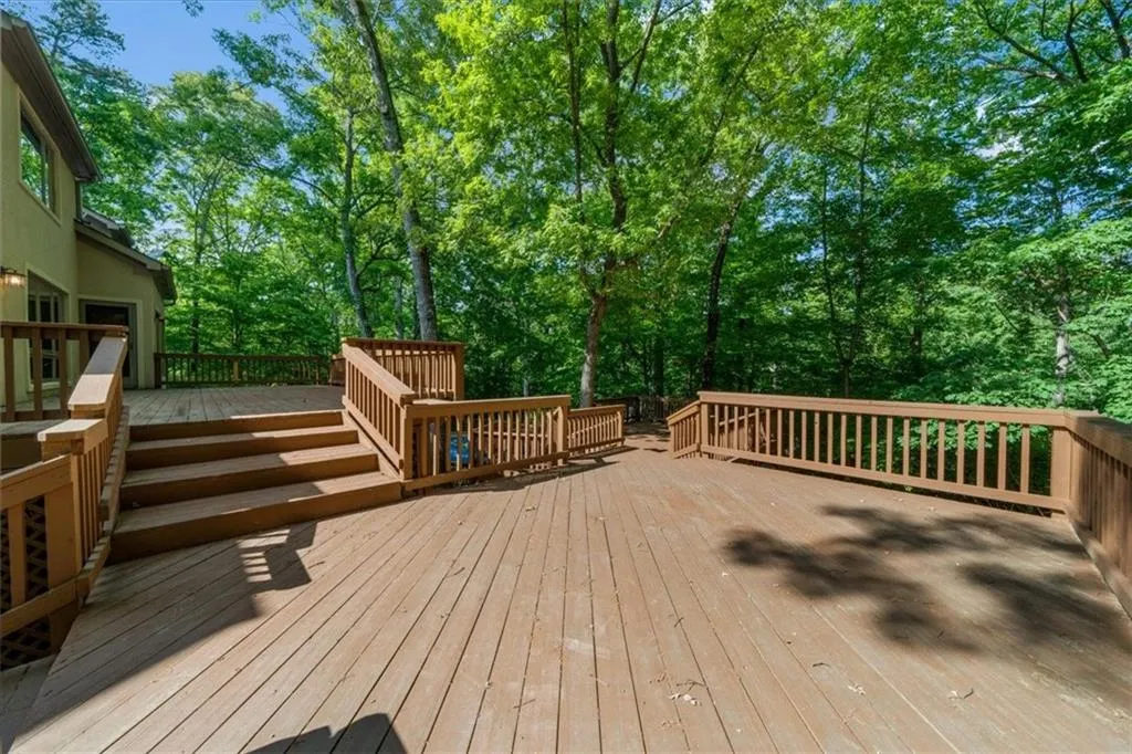 Wooden deck featuring view of wooded area