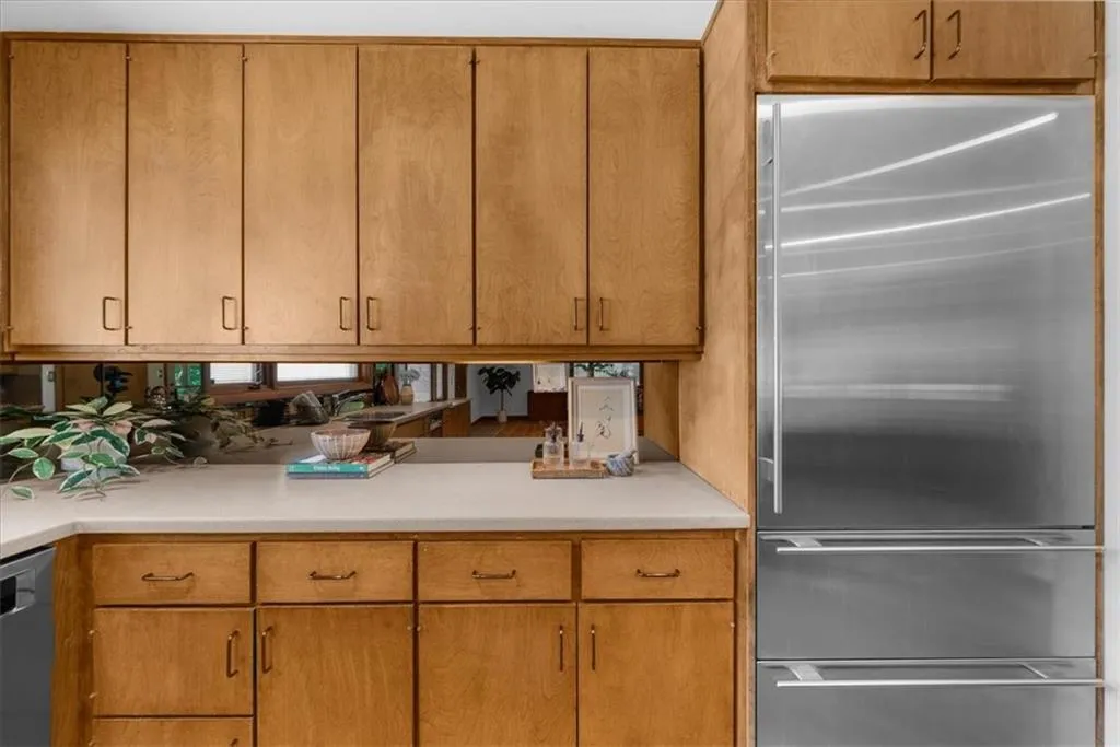 Kitchen with stainless steel appliances and light countertops