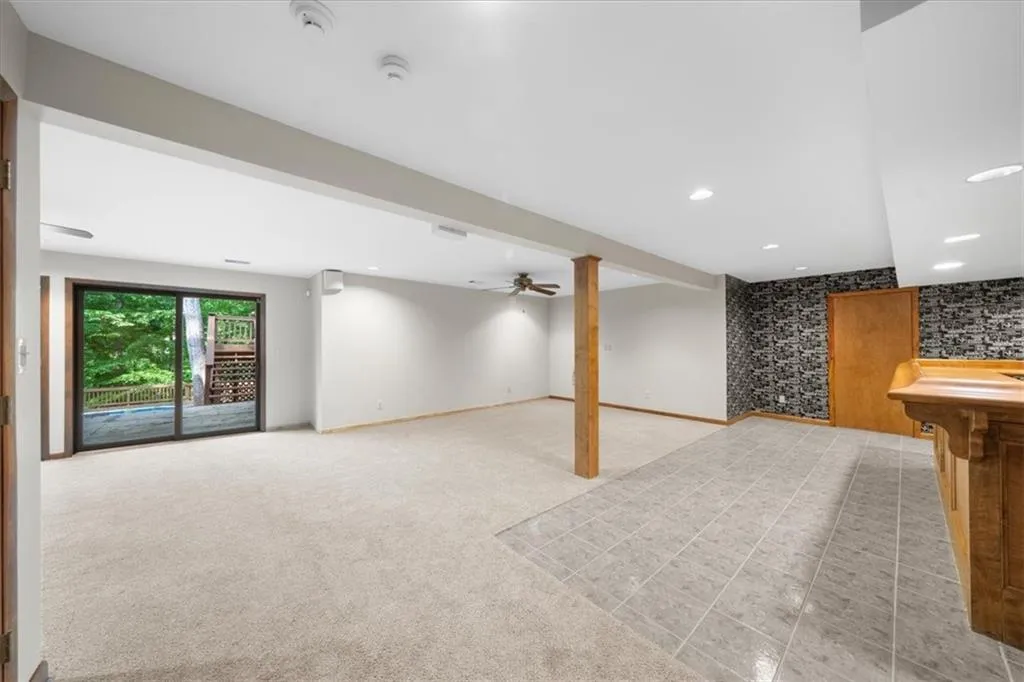 Basement with light colored carpet and recessed lighting