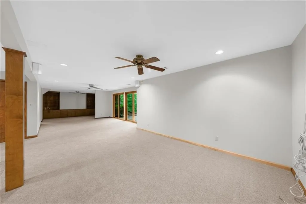 Unfurnished living room featuring light colored carpet, recessed lighting, baseboards, and a ceiling fan