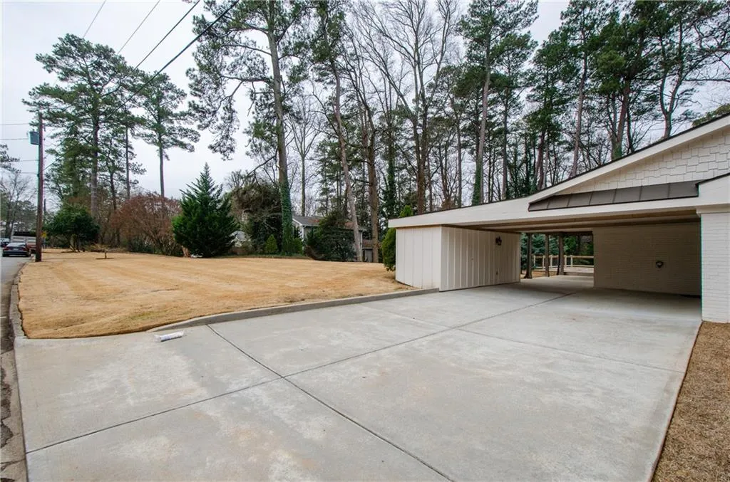View of patio / terrace with driveway and an attached carport