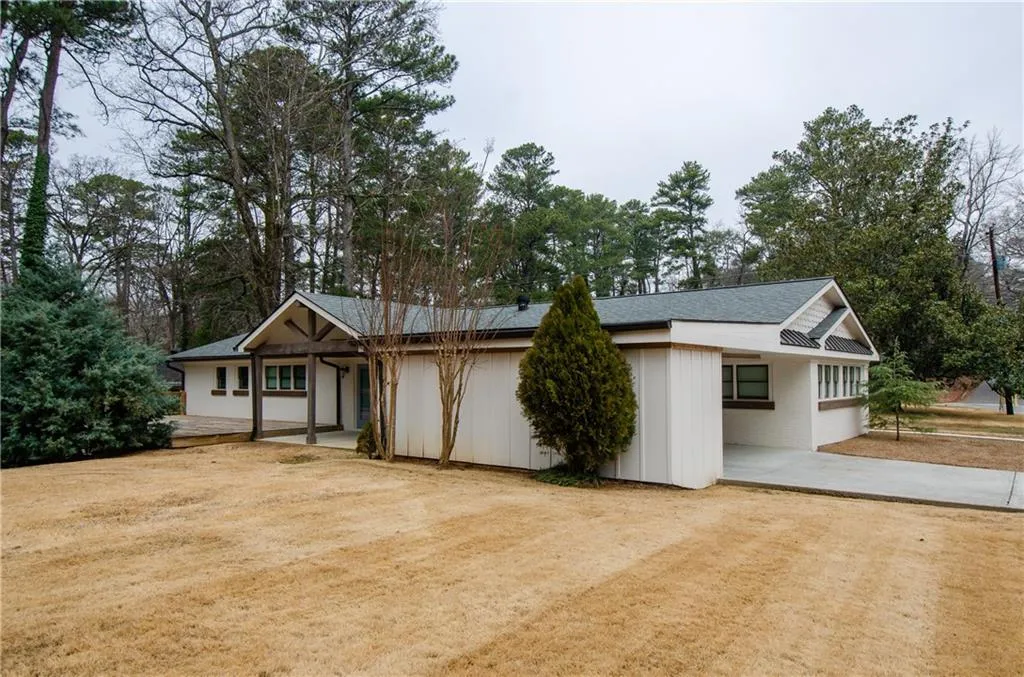View of front of home with concrete driveway and a patio area