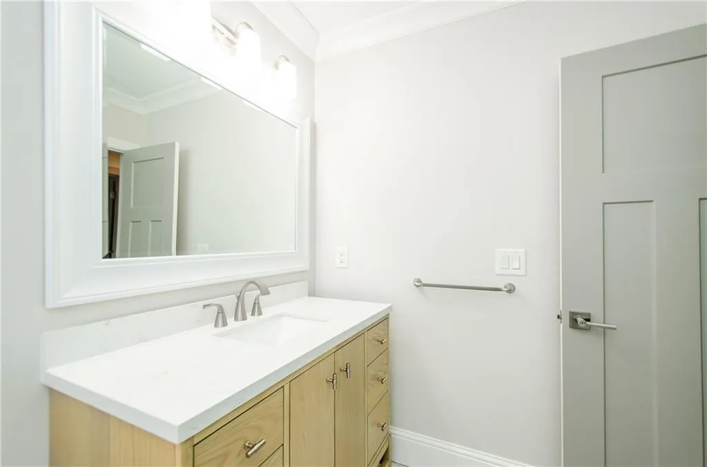 Bathroom with vanity and crown molding