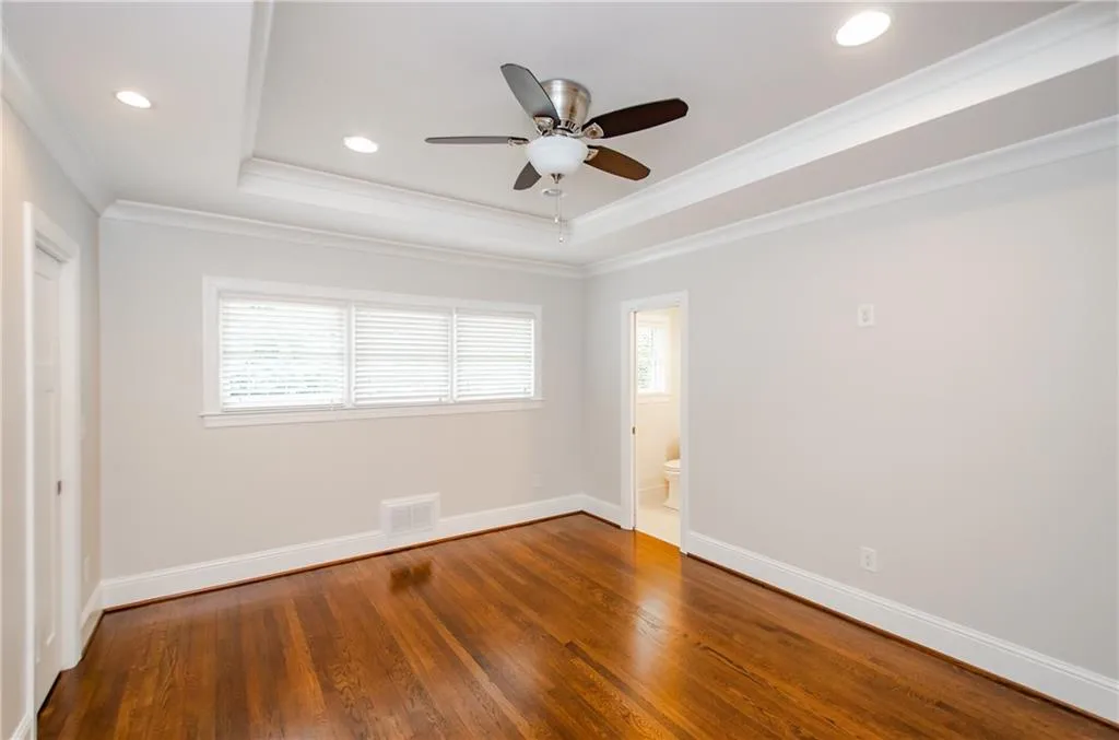 Unfurnished room featuring ceiling fan, wood-type flooring, recessed lighting, healthy amount of natural light, and crown molding