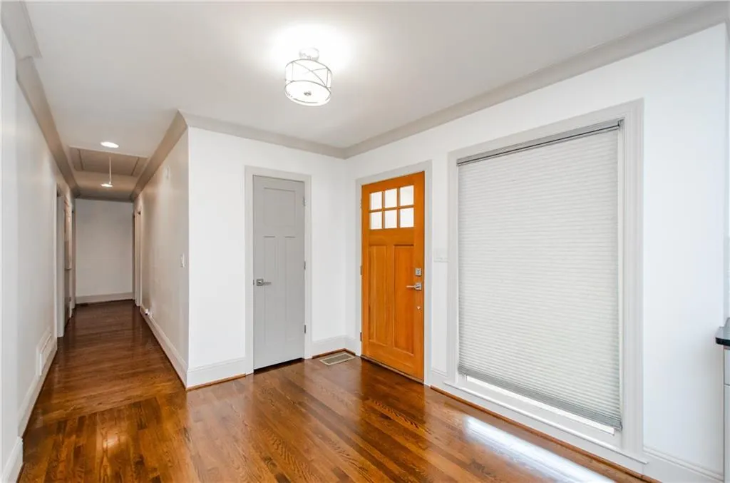 Entryway with wood-type flooring and recessed lighting
