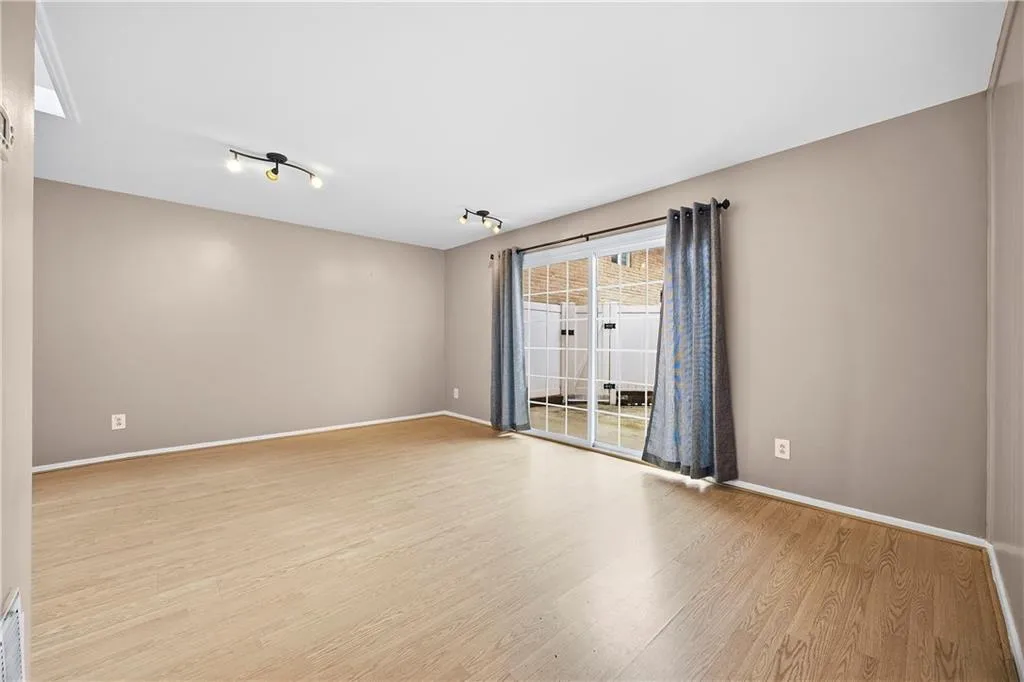 Unfurnished room featuring light wood finished floors and baseboards