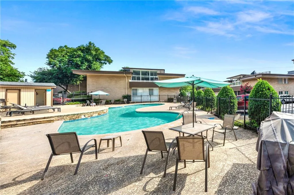 Community pool with a patio and area for grilling