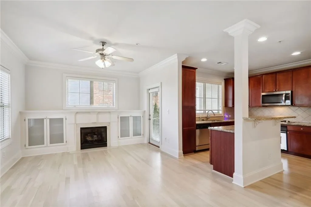 Open concept living room and kitchen with refinished floors. Gas log fireplace and lots of natural light!