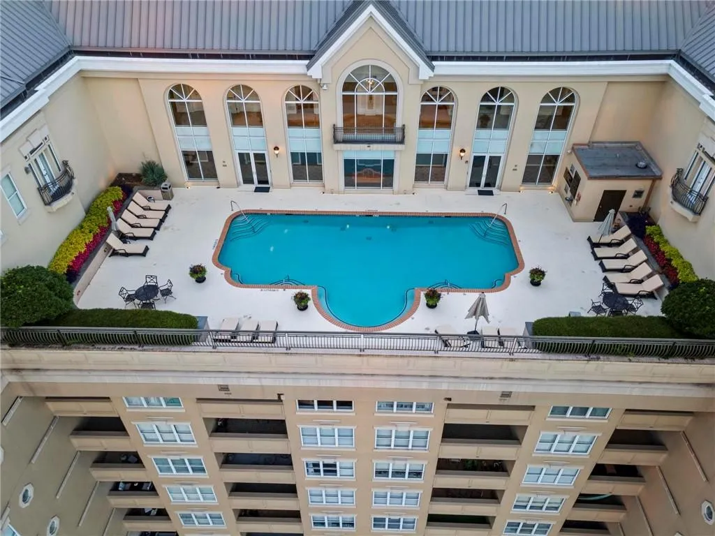 Community pool with a patio