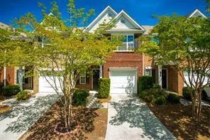 Obstructed view of property with driveway and an attached garage