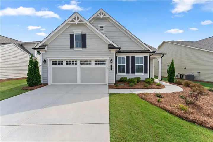 Light gray exterior paint, dark colored accents with shutters, gutters and roof. Window transomed 2-car attached garage