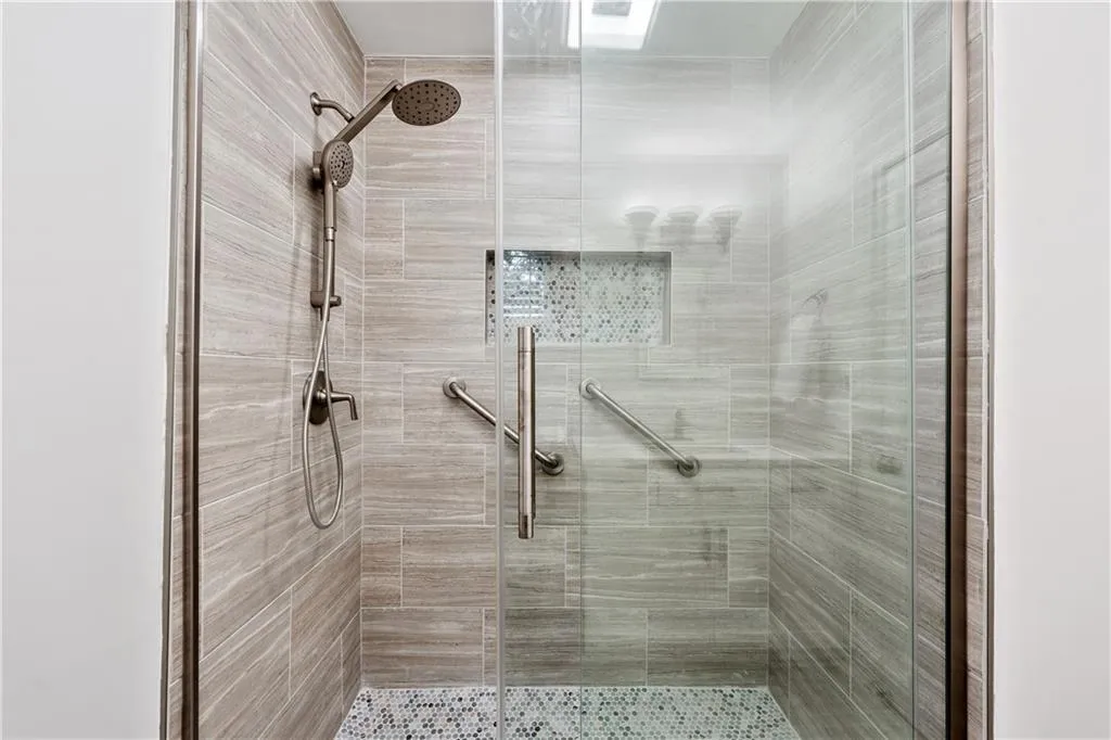 New shower with new tile and new premium Kohler soft close door.