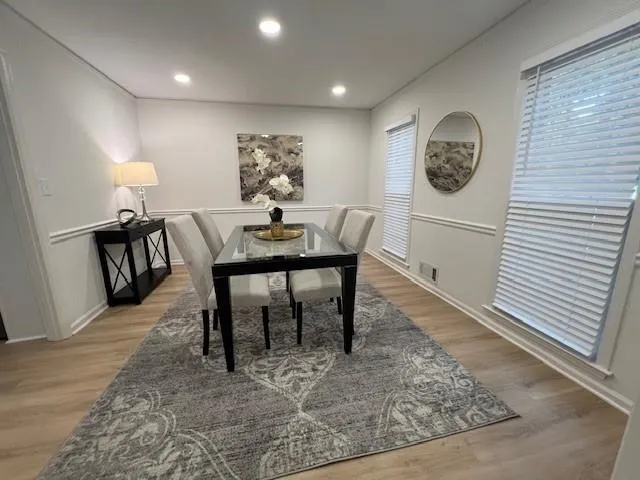 Dining room featuring new flooring, new paint and new lighting.