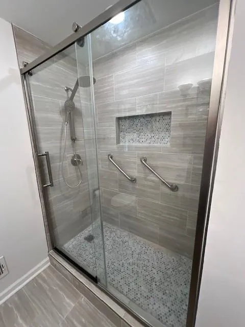 Primary bathroom with new tile, new Kohler soft close shower door.