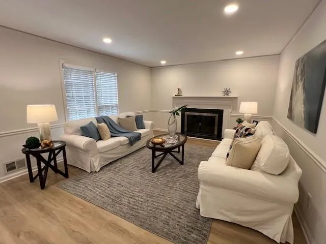 Large room for family gatherings.  New lighting, new paint, new flooring.