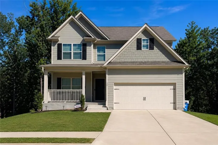 Two-story residence featuring light gray siding and dark gray accent shingles