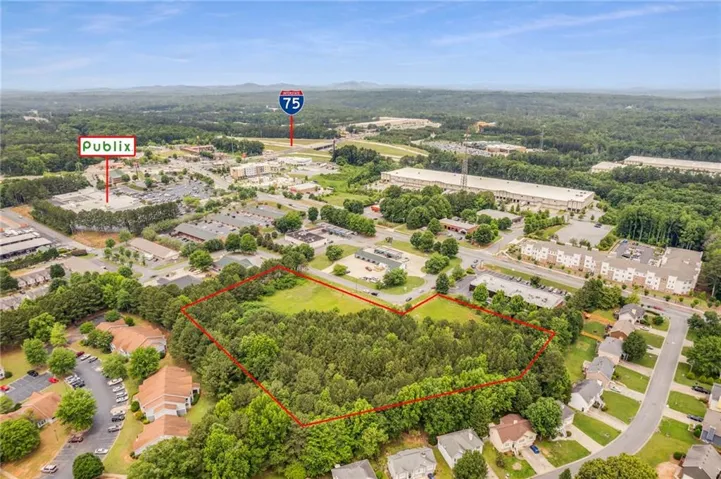 Excellent location! Close to I-75 4.66 acres Zoned C2. Property is located in the City Limits of Acworth. Road is paved in front of property curb and sewer is in the street.  533 ft. Road frontage.