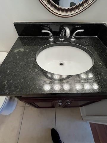 Details of bathroom vanity and travertine tile flooring