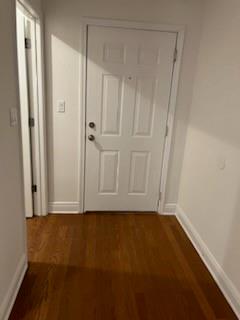 Hallway featuring dark wood-type flooring