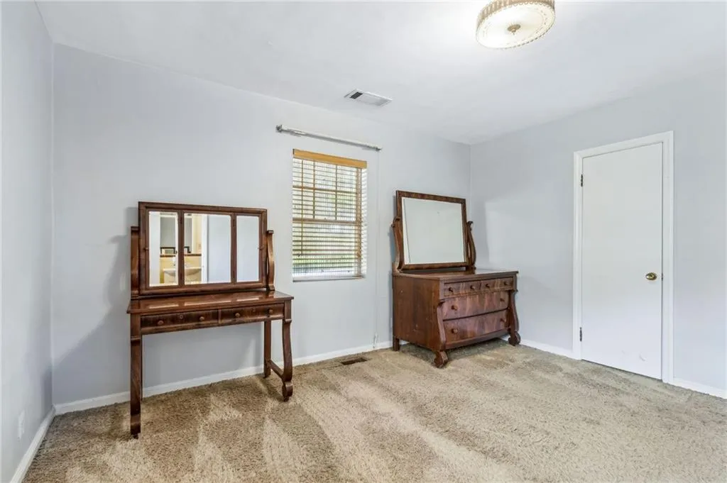 Primary Bedroom with light colored carpet