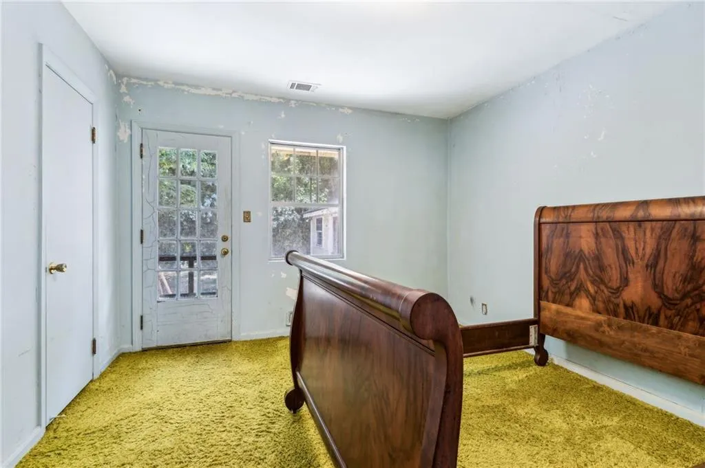 Bedroom featuring access to exterior and carpet floors