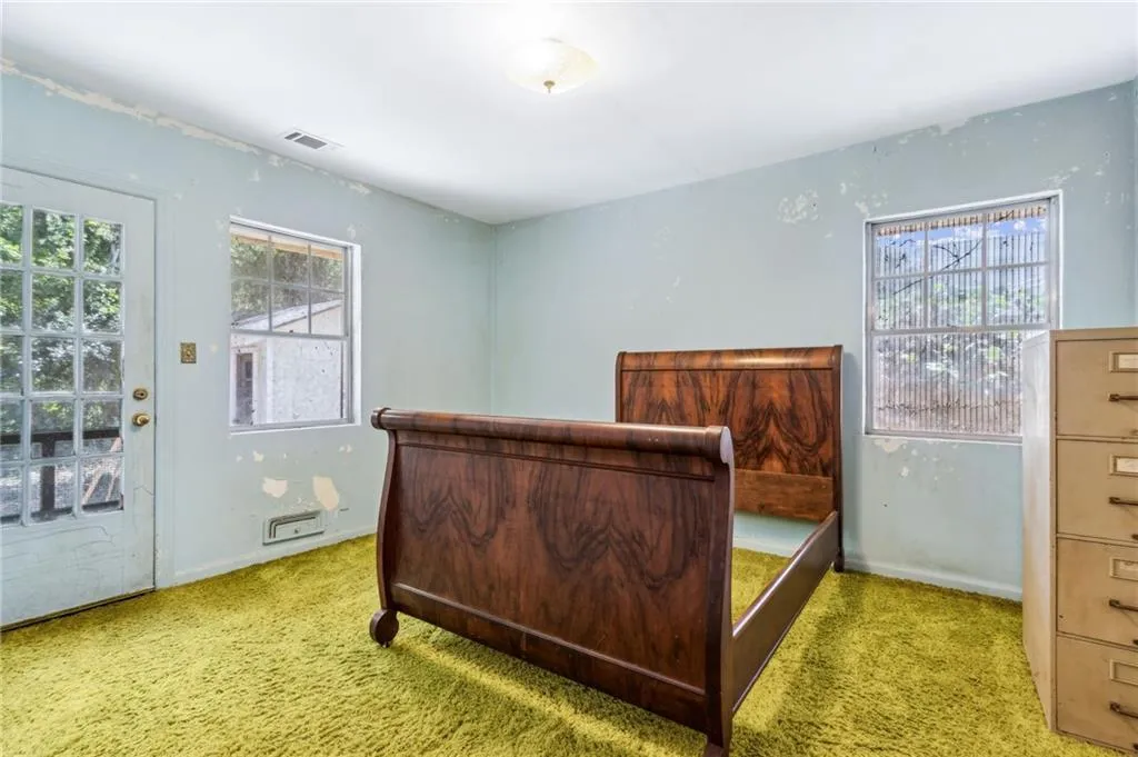 Bedroom with access to exterior and carpet floors