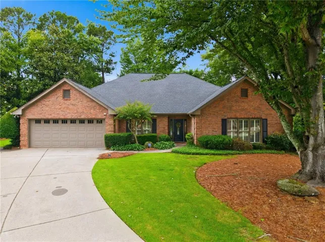 Brick Ranch with dark gray shingle roofing