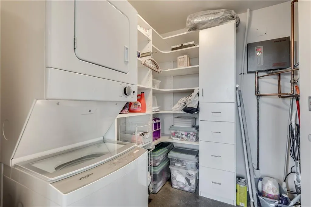 Washroom with stacked washer and clothes dryer
