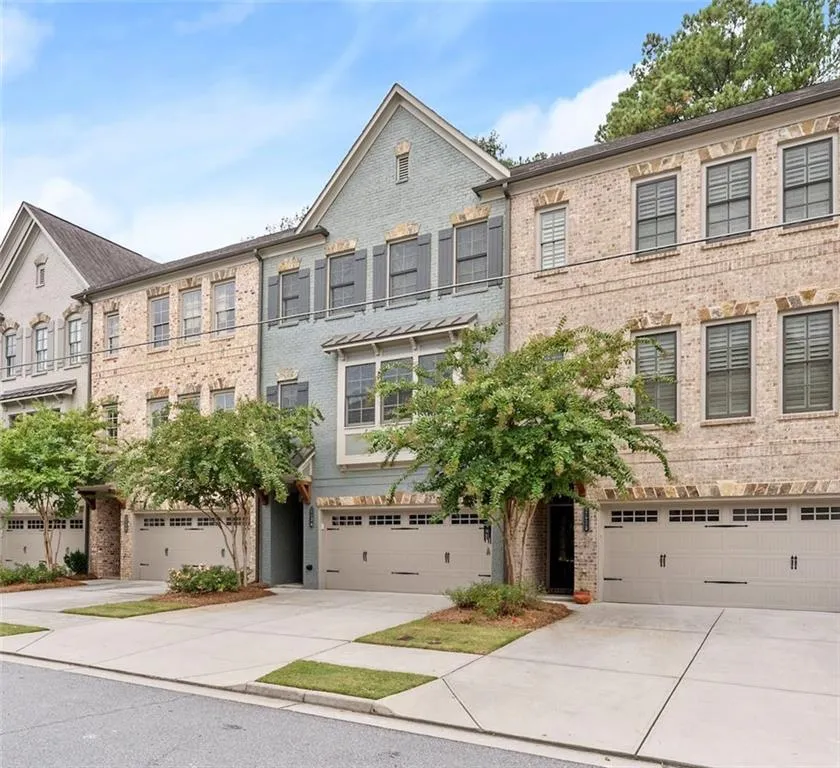 French country style house with brick siding, driveway, and an attached garage