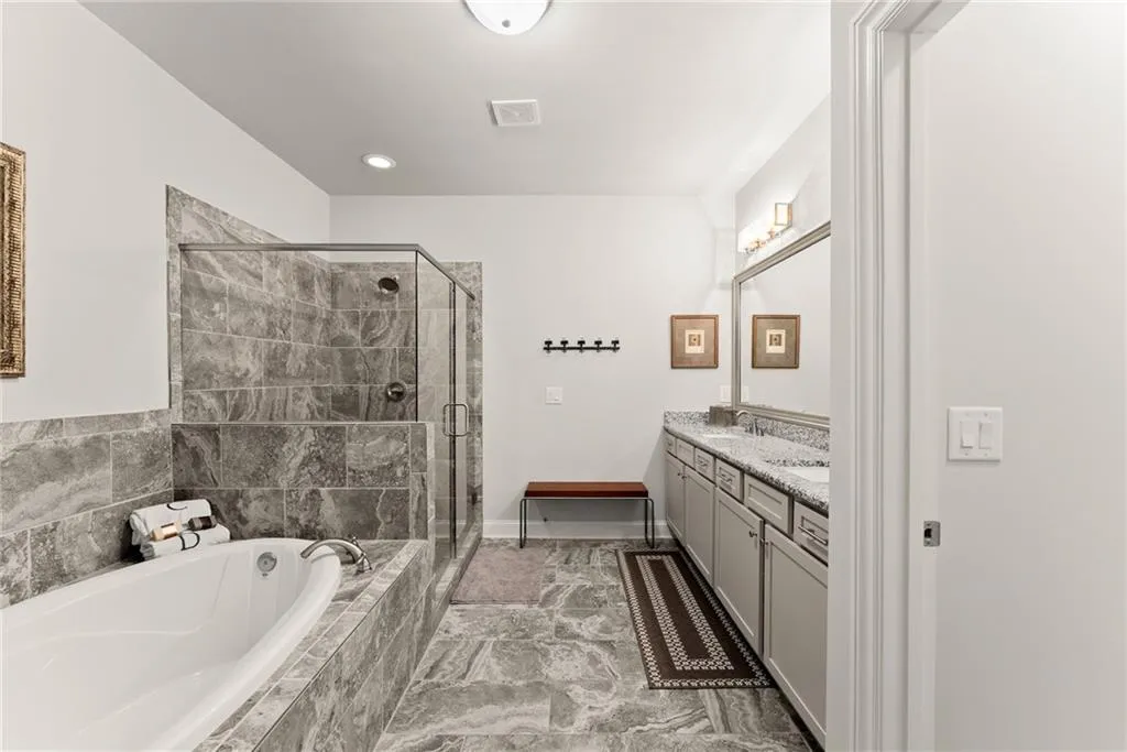 Full bath with a bath, double vanity, a stall shower, and recessed lighting