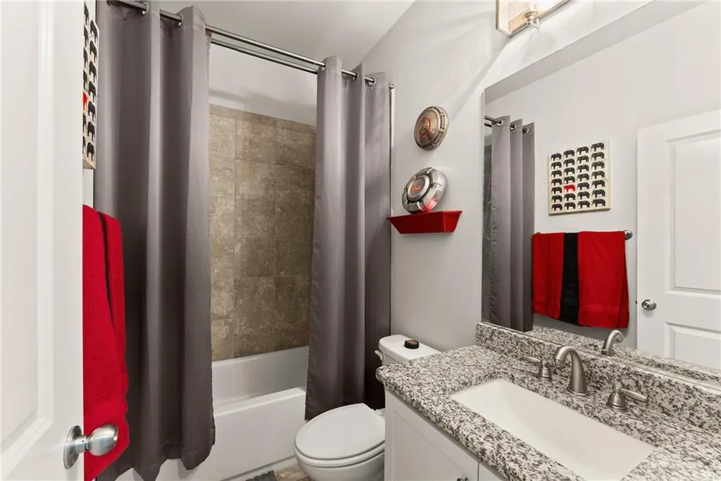 Bathroom with vanity and shower / bath combination with curtain